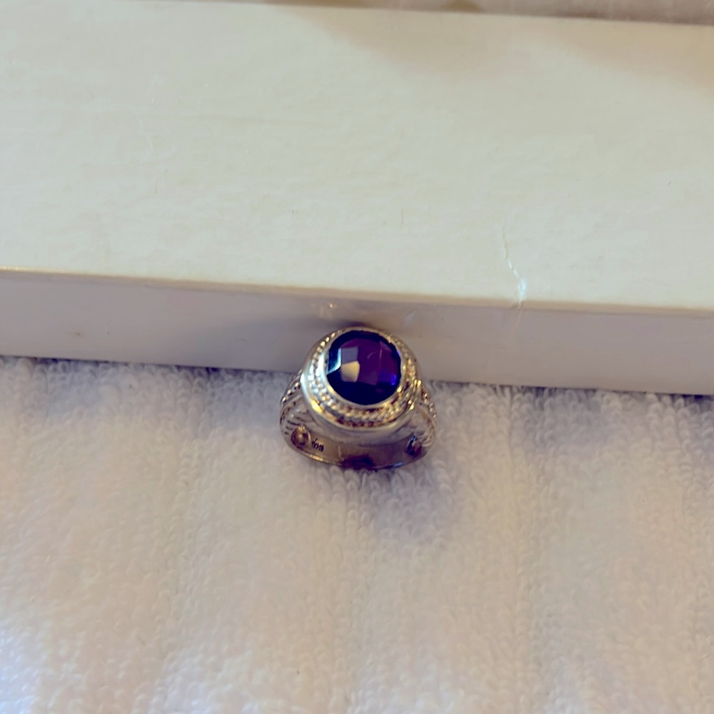 Sterling silver ring with purple stone.